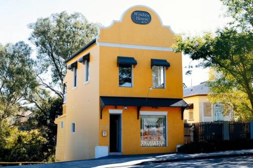 a yellow building with a sign on top of it at Harry Potter Themed Apartment Brisbane in Brisbane