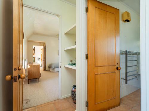 a door leading into a room with a hallway at Beachfront Landing - Pauanui Holiday Home in Pauanui