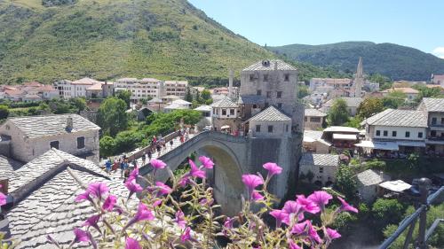 a large building with a clock tower in the middle of it at Apartments Old Bridge in Mostar