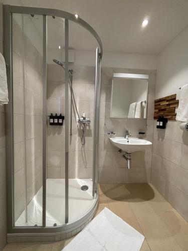 a bathroom with a shower and a sink at Chesa in Selva in St. Moritz