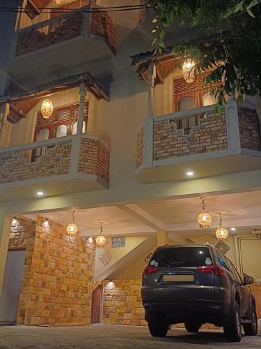 a black car parked in front of a building at PearlDrop Hills Kandy in Kandy