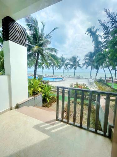 a balcony with a view of the beach at Resort HAVANA in Mui Ne