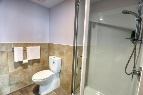 a bathroom with a toilet and a shower at Marsden Suites Albany in Albany