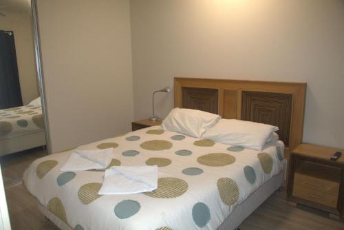 a bedroom with a bed with two towels on it at Unit 66 Seafront Estate in Jurien Bay