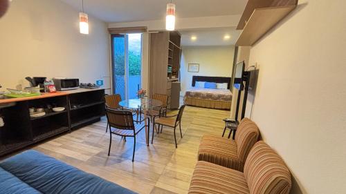 a living room with a couch and a dining room at Loft Huamuche San Sebastián Tutla in Yelateni