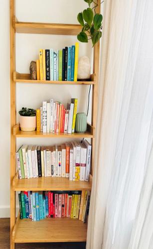 a book shelf filled with books and a plant at The View on Castle Hill with Lovely Hot Tub in Conwy