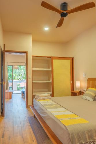 a bedroom with a bed and a ceiling fan at Casa Cactus Buenavista in Bacalar