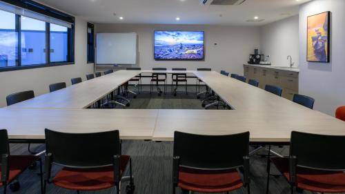 a large conference room with a large table and chairs at Marsden Suites Albany in Albany