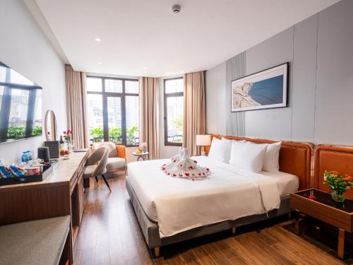 a hotel room with a bed with a cake on it at San Hanoi Hotel & Gaming in Hanoi