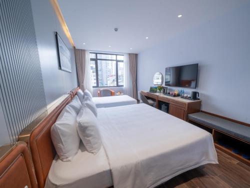 a hotel room with a bed and a television at San Hanoi Hotel & Gaming in Hanoi