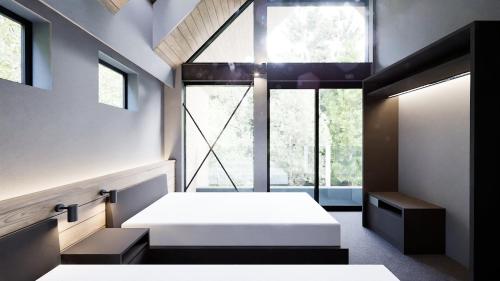 a bedroom with two beds and a large window at Hakuba Aurora Chalet by Jade Group in Hakuba