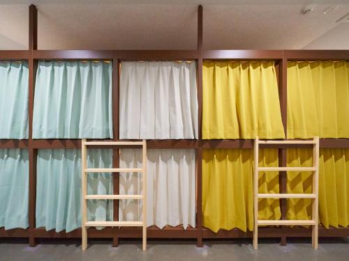 a room with several different colored curtains at Retrospect Stay Yokohama in Yokohama