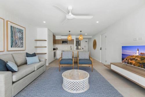 a living room with a couch and a table at Fairshore in Noosa Heads