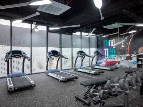 a row of exercise bikes in a gym at Tru by Hilton Da Nang City Centre in Da Nang