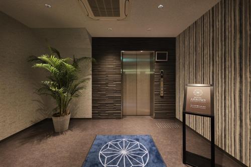 a lobby with a door and a blue rug at HOTEL ARROWS Arashiyama in Kyoto