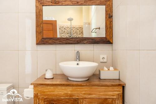 a bathroom with a sink and a mirror at Pondok Bagus by Bukit Vista in Canggu