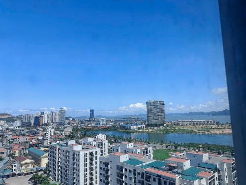 a view of a city with a river and buildings at Homestay Hạ Long NewLife in Kon Rung (1)