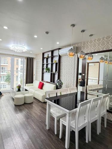 a living room with a couch and a table at Homestay Hạ Long NewLife in Kon Rung (1)