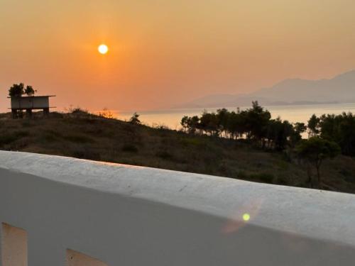 a sunset from the roof of a house with a bench at MirSea - Luxury stay Alepochori in Megara