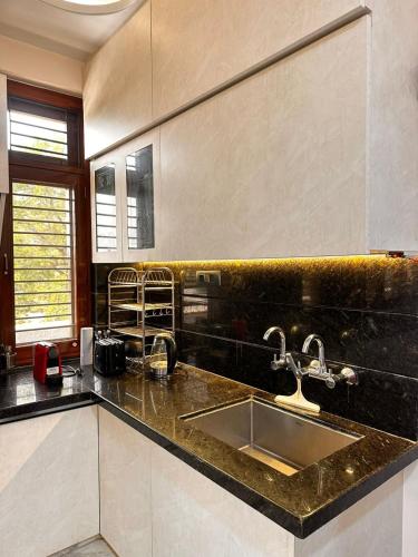 a kitchen with a sink and a counter top at Shanti vilas in Jaipur