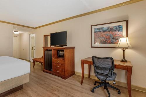 a hotel room with a bed and a desk and a chair at Best Western PLUS Morristown Inn-Florham Park in Morristown
