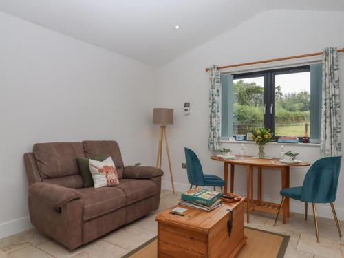 a living room with a couch and a table at The Pennymoor in Tiverton
