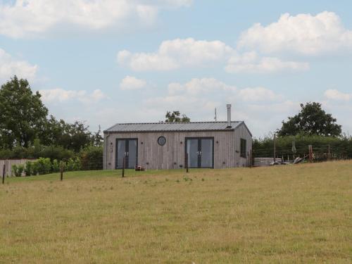 a building in a field with a grass field at The Pennymoor in Tiverton