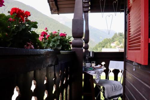 a balcony with a table and flowers and a view at Haus Berta, Montafon in Partenen
