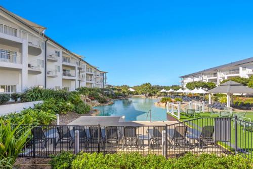 a view of a river between two apartment buildings at Park View Apartment in Mantra Salt Resort by uHoliday - 2BR, 1BR and Hotel Room configurations available in Kingscliff
