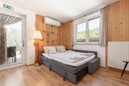 a bedroom with a bed in a room with windows at Turistična kmetija Marovt in Bled