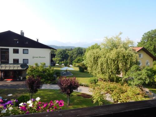 a view from the balcony of a hotel with flowers at Hotel Garni Wurzer in Velden am Wörthersee