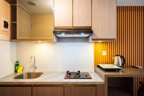 a kitchen with a sink and a counter top at Tokyo Riverside Apartment @ PIK 2 in Tangerang