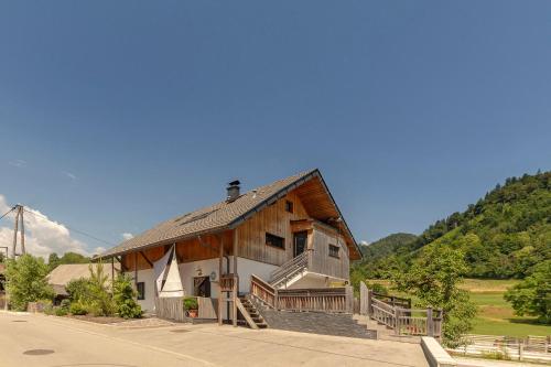 a large wooden house with a porch on a street at Turistična kmetija Marovt in Bled