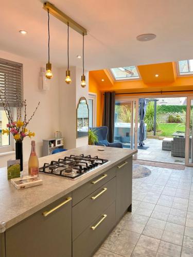 a kitchen with a stove top oven in a room at Tranquil Victorian Villa with Hot Tub & Sauna in Colwyn Bay