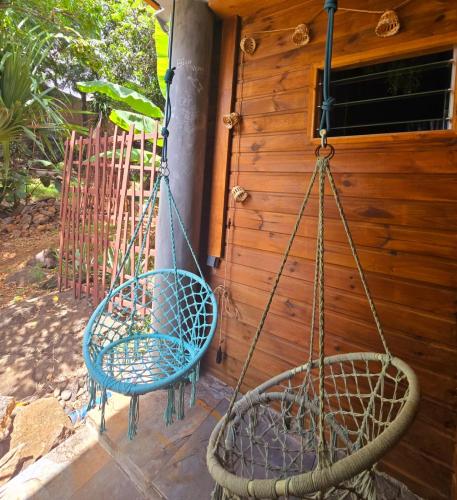 two swings hanging from a house at Le reflet exotique in Saint-Pierre