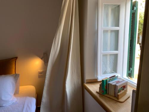 a bedroom with a bed and a window at BougainVilla in Vonitsa