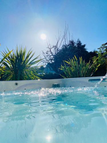 a swimming pool with water being poured into it at Tranquil Victorian Villa with Hot Tub & Sauna in Colwyn Bay
