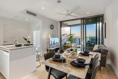 a kitchen and dining room with a table and a kitchen and a living room at Iconic Views - Queen's Wharf 1BR - Casino & South Bank in Brisbane