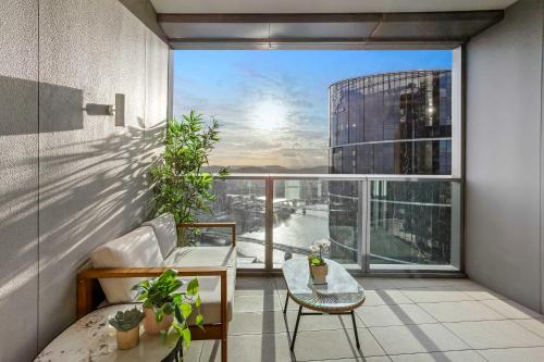 an apartment balcony with a view of a city at Iconic Views - Queen's Wharf 1BR - Casino & South Bank in Brisbane