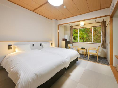 Giường trong phòng chung tại Noboribetsu Manseikaku