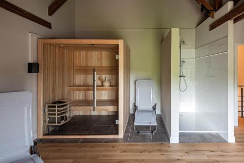 a room with a refrigerator and a glass door at Storchenhof Blumenow in Blumenow