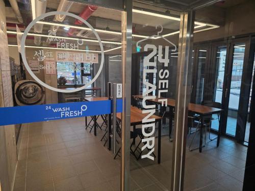a restaurant with a table and a sign on the door at Shinchon Maven Hotel in Seoul