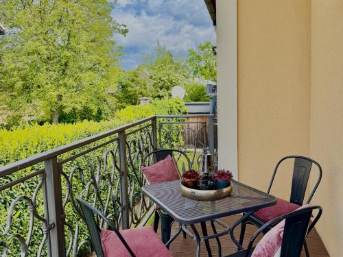 a table and chairs on a balcony with a view at Villa Salzburg by Welcome to Salzburg in Salzburg