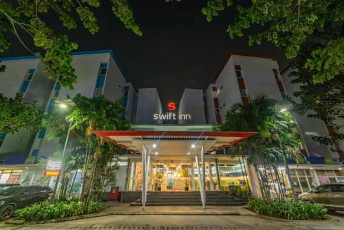 a store front of a hotel at night at Swift Inn Aeropolis Airport in Tangerang