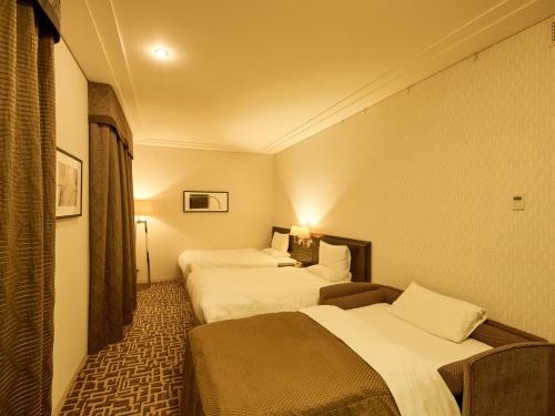 a hotel room with two beds in a room at Okura Chiba Hotel in Chiba