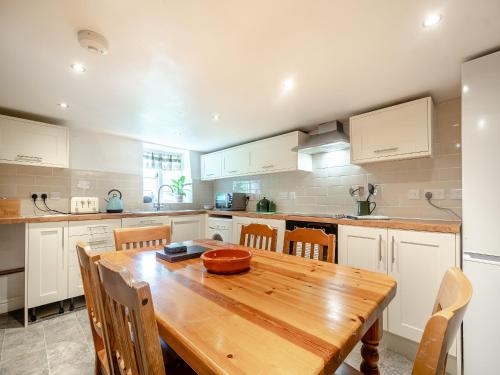 a large kitchen with a wooden table and chairs at Bengough's Annexe in Berkeley