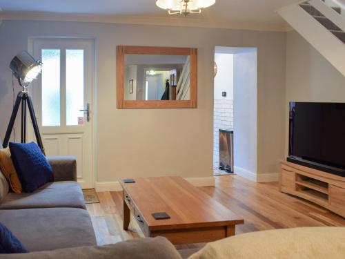 a living room with a couch and a table at Castle Street Cottage in Narberth