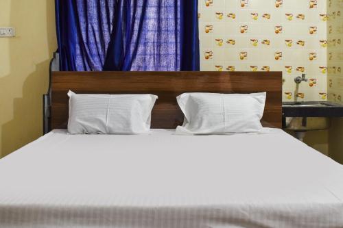 Ένα ή περισσότερα κρεβάτια σε δωμάτιο στο Hotel O Sai Residency