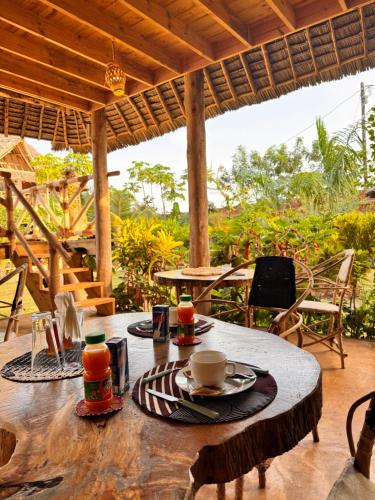 a table with a cup of coffee on top of it at Jumanji B&B in Kinyasini
