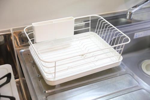 a white dish rack in an open dishwasher at シティラデファンス - 2025年6月室内リニューアル in Sapporo